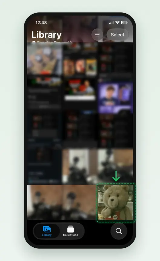 Screenshot of the Photos app on an iPhone: Library, with the saved GIF as the newest tile at the bottom right, marked. The other photos are blurred.