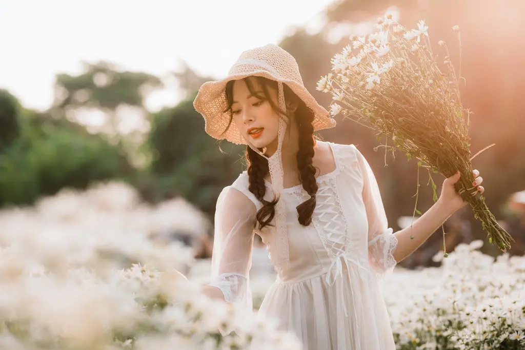 PNG to JPG converter, before: a woman in a straw hat holding dried flowers in warm backlight, PNG, 1.5 MB