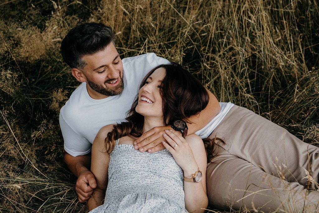 pixelate online, before: a laughing couple lying together in dry golden grass, Original, 269.2 KB